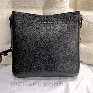 Michael Kors pebbled leather black messenger bag.